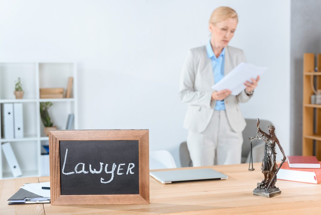 Lawyer reviewing documents in an office, illustrating administrative work a virtual receptionist can reduce